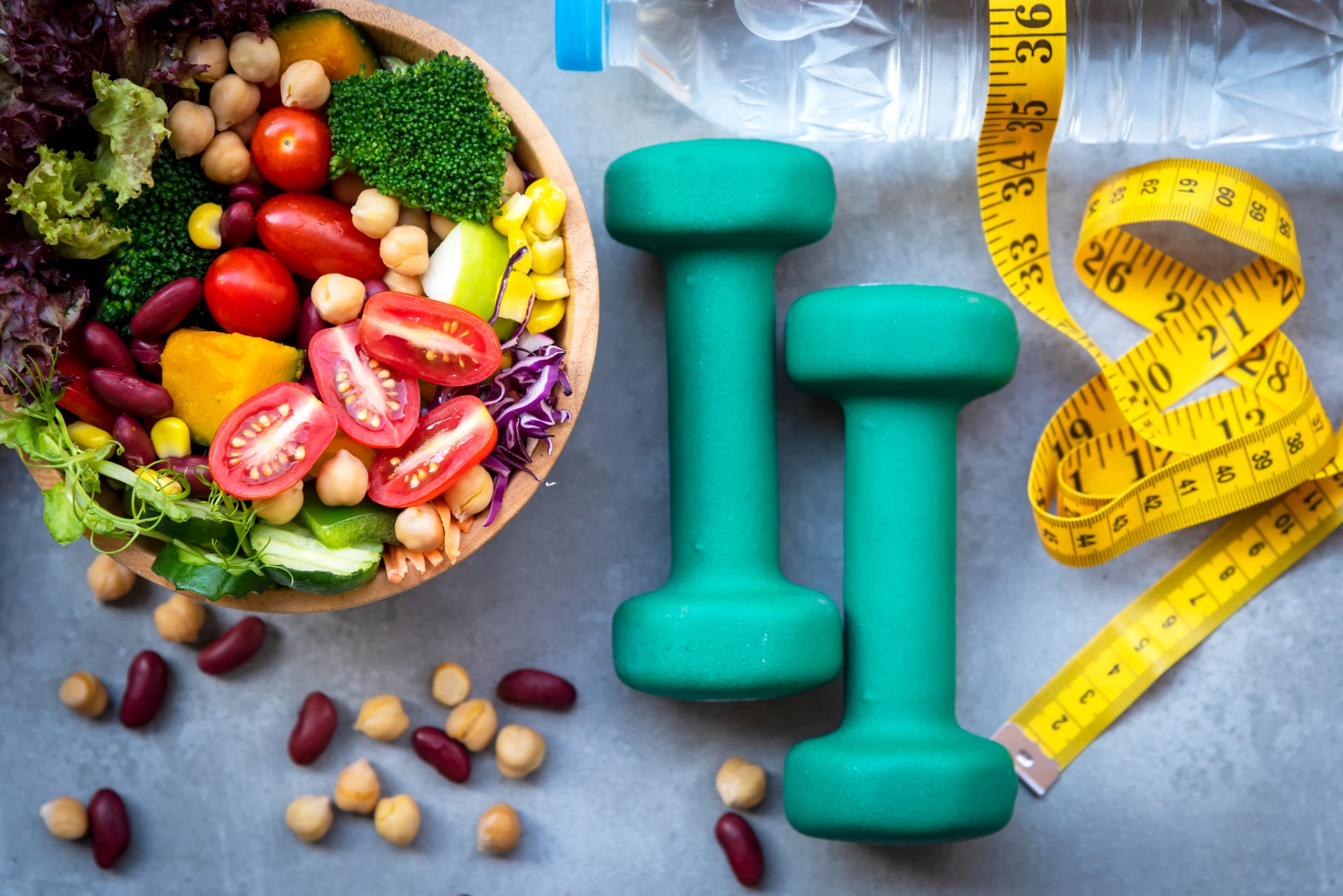 Fresh-vegetable-salad-and-healthy-food-for-sport-equipment-for-women-diet-slimming-with-measure-tap-for-weight-loss-on-wood-background.-Healthy-Sport-Concept-1167778624_7000x4672-scaled